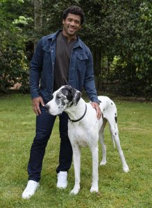 Pro football champion and pet advocate Russell Wilson poses for a photo with his dog, TBD, while filming a Safer Together public service announcement (PSA) with the Banfield Foundation on Wednesday, May 15, 2019, in Redmond, Wash. The PSA is now airing nationally, timed with National Domestic Violence Awareness Month, to help drive awareness that pets are often victims of domestic violence too. Many domestic violence victims stay in abusive situations because they fear for the safety of their pet, so the Banfield Foundation aims to educate and provide resources for pet owners, advocates and communities to help make a difference for pets and the people who love them. (Stephen Brashear/AP Images for the Banfield Foundation)